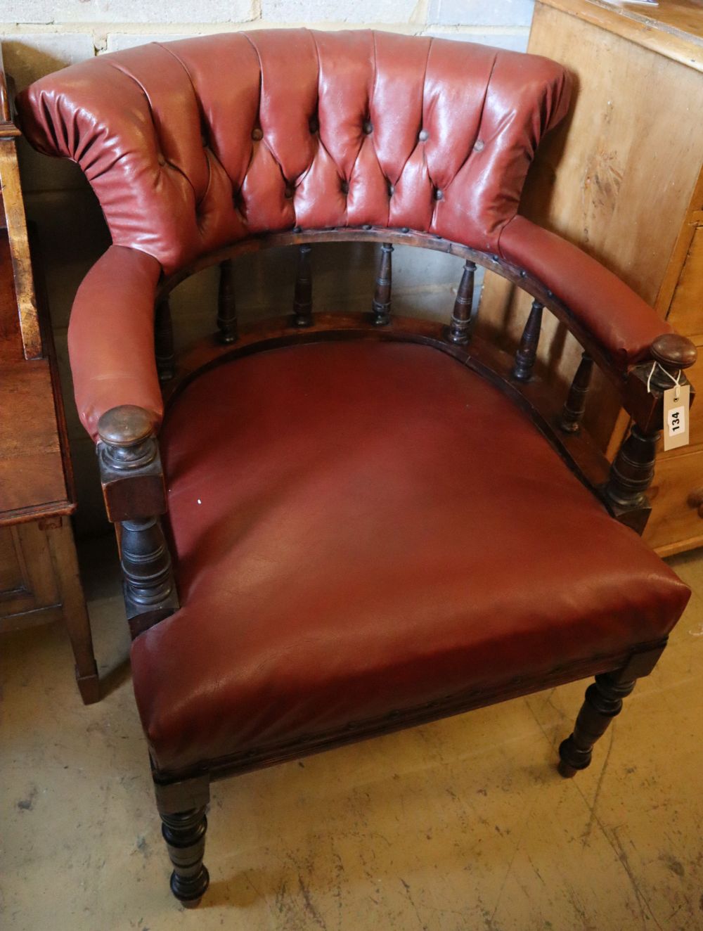 A Victorian mahogany tub frame library chair upholstered in buttoned upholstery, width 66cm